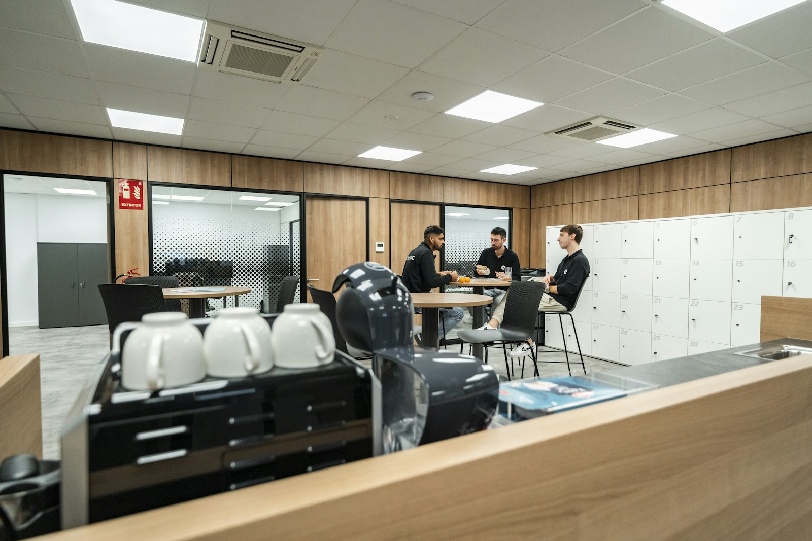 Colleagues sharing a coffee break in their workplace kitchen